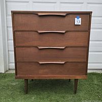 Front view showing four drawers and tapered legs