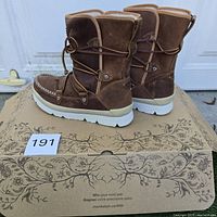 Pair of brown Manitobah Mukluks Pacific Half boots displayed on original box