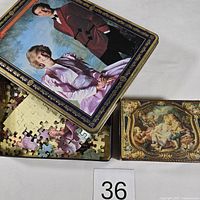 Puzzle tin lid removed showing portrait of Prince Charles and Princess Diana, inner tray with loose puzzle pieces, and additional small candy tin