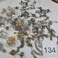 Wide view of entire assortment spread on table with lot tag 134