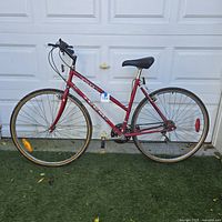 Full side view of red CCM ladies bicycle showing overall condition