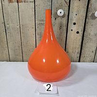 front view of orange glass teardrop shade