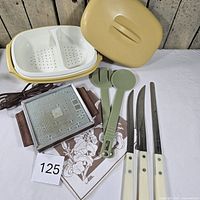 Group shot of all items including steamer, utensils, warming tray, napkin