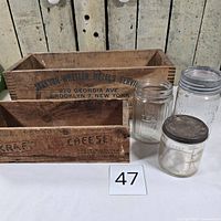 Group shot showing both wood crates and three jars
