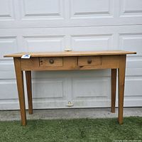 Front view of wood console table displaying both drawers and legs