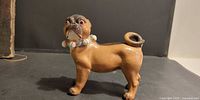 side view of porcelain pug dog figurine