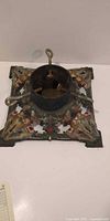 Top view of cast iron Christmas tree stand square base