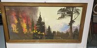 Front view of framed wildfire landscape painting