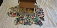 Open box surrounded by loose vintage hockey cards