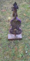 Front view of driftwood and metal violin sculpture on wood base