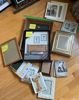 Overhead view of all twenty frames showing variety of sizes, materials and mats