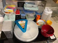 overall view of assorted plastic containers, bowls and pitcher on stovetop