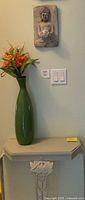 Console table front view with vase and wall plaque