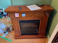 Front view of electric fireplace with accessories on mantel