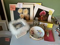 Overall view showing floral prints, keepsake box, porcelain dish, perfume bottle, pouch and hair accessories