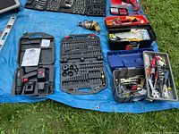 Close view of power drill, bit sets, and toolbox contents
