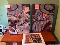 Front view of two canvas prints and framed print