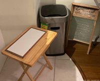 Tray table, stainless trash can, vintage washboard overview