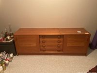 Front view of walnut sideboard showing full length, cabinet doors, drawers