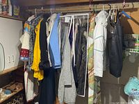 Row of assorted women’s coats and jackets hanging on rack