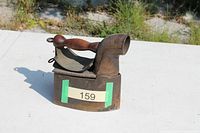 Left side view of antique coal iron showing body shape and number tag