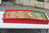 Full view of wooden tabletop hockey game board on table