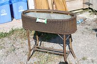 Full view of wicker plant stand showing legs and liner