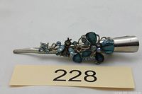 Top view of hair clip showing full length and floral blue stone decoration