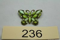 Front view showing butterfly design and green stones