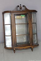 Front view of oak curio cabinet closed