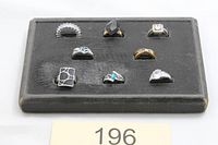 All eight rings arranged on black tray overview