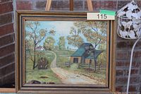 Full view of framed painting on easel