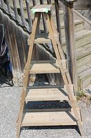 Front view of wooden A-frame shelf with four shelves