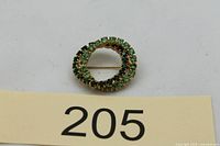 Front view showing brooch shape and stones