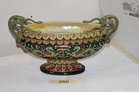 Full view of footed maiolica vase showing snake handles and painted decoration