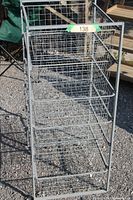 Front view of gray metal wire rack showing six wire baskets in frame