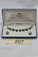Open presentation box displaying necklace and earrings