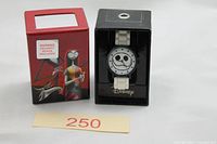 Watch in black display box next to red outer sleeve