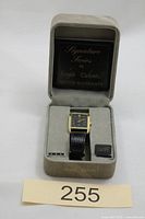 Watch in open presentation box showing dial, strap and warranty card