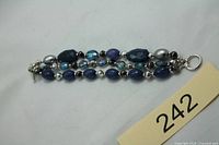 Full view of double-strand bracelet showing bead arrangement and ring clasp