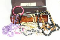 Overall lot showing chest and assortment of jewellery spilling out