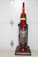 Full view of red Hoover upright vacuum cleaner on floor