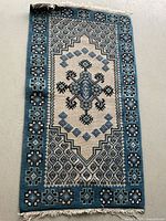 Full view of rug lengthwise displaying entire pattern and fringe