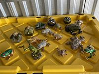 Full lot overview showing all frog figurines and trinket boxes on yellow tray