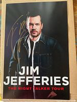 Front view of signed poster showing full design and autograph