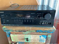 Front view of Onkyo receiver showing overall unit and controls