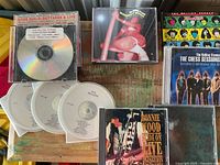 Group shot of all CDs on wooden surface