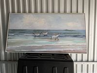 Full view of framed stretched canvas showing entire beach scene with three sandpipers