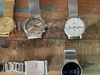 Group shot of all five watches showing variety and condition