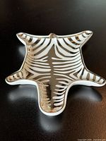 Oblique top view of zebra dish showing silver stripes and shape